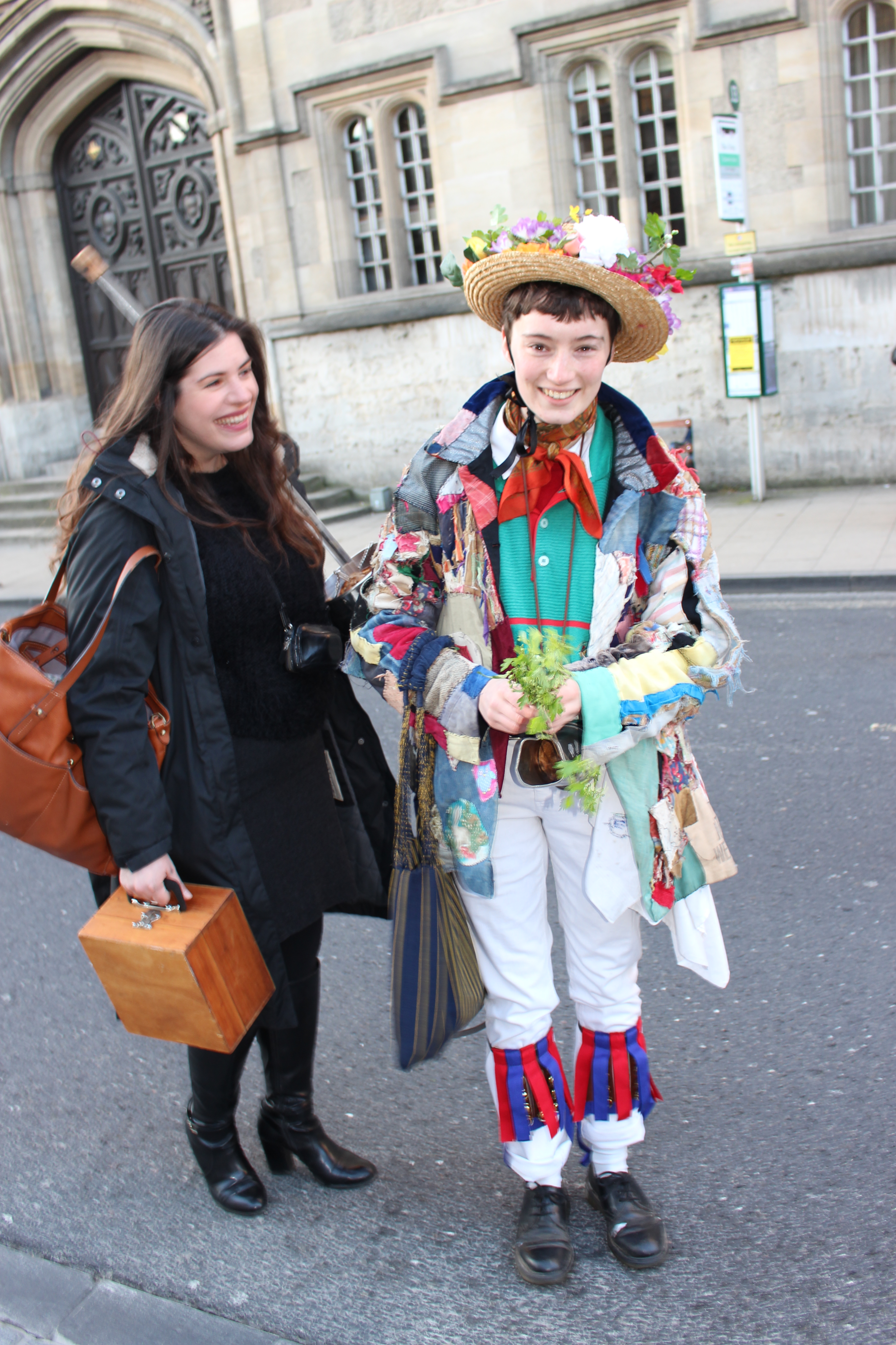 Morris dancer in flower-bedecked hat, High Street, Oxford, May 
Morning.
