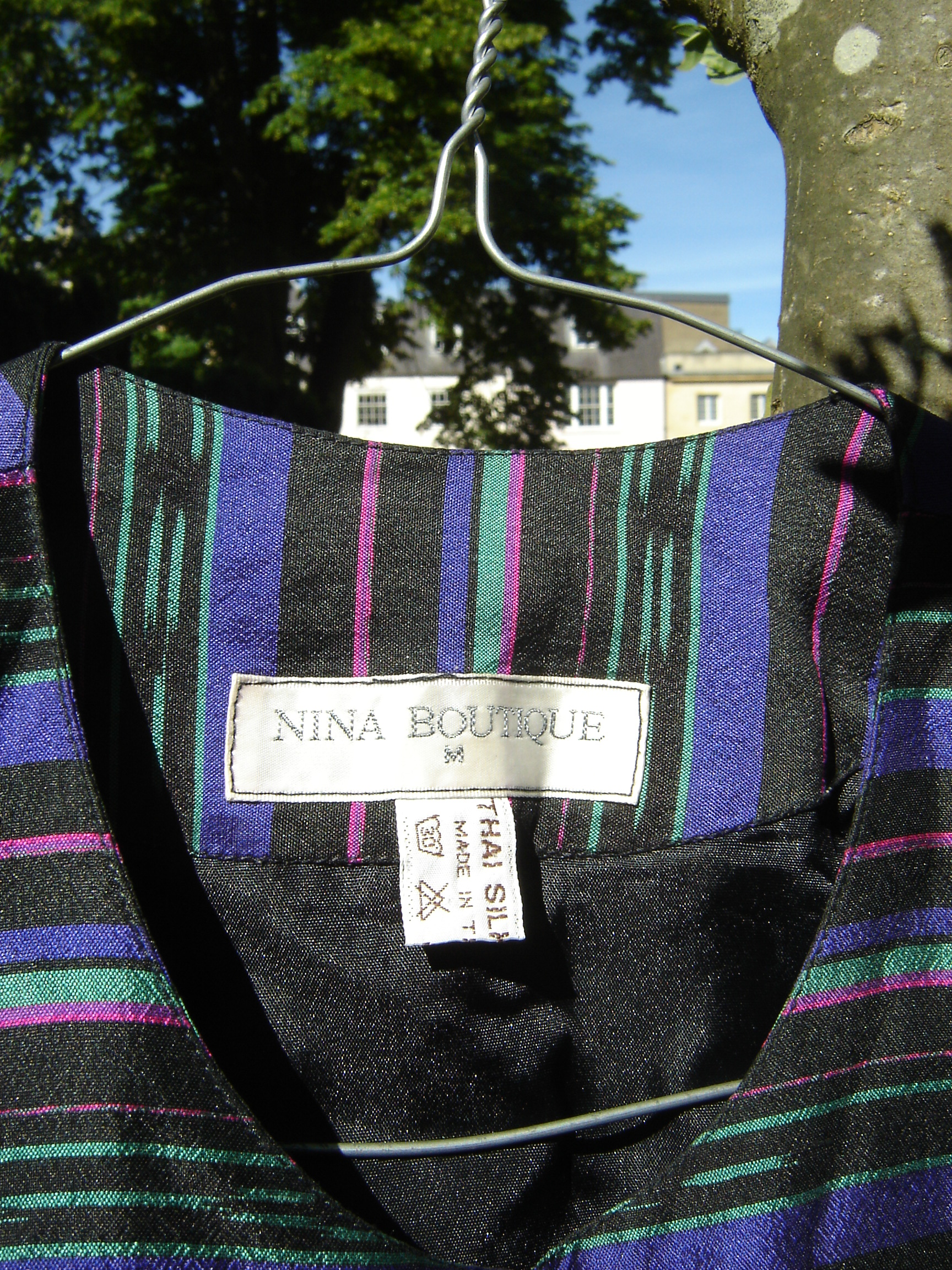 Nina Boutique striped silk top, showing label.
