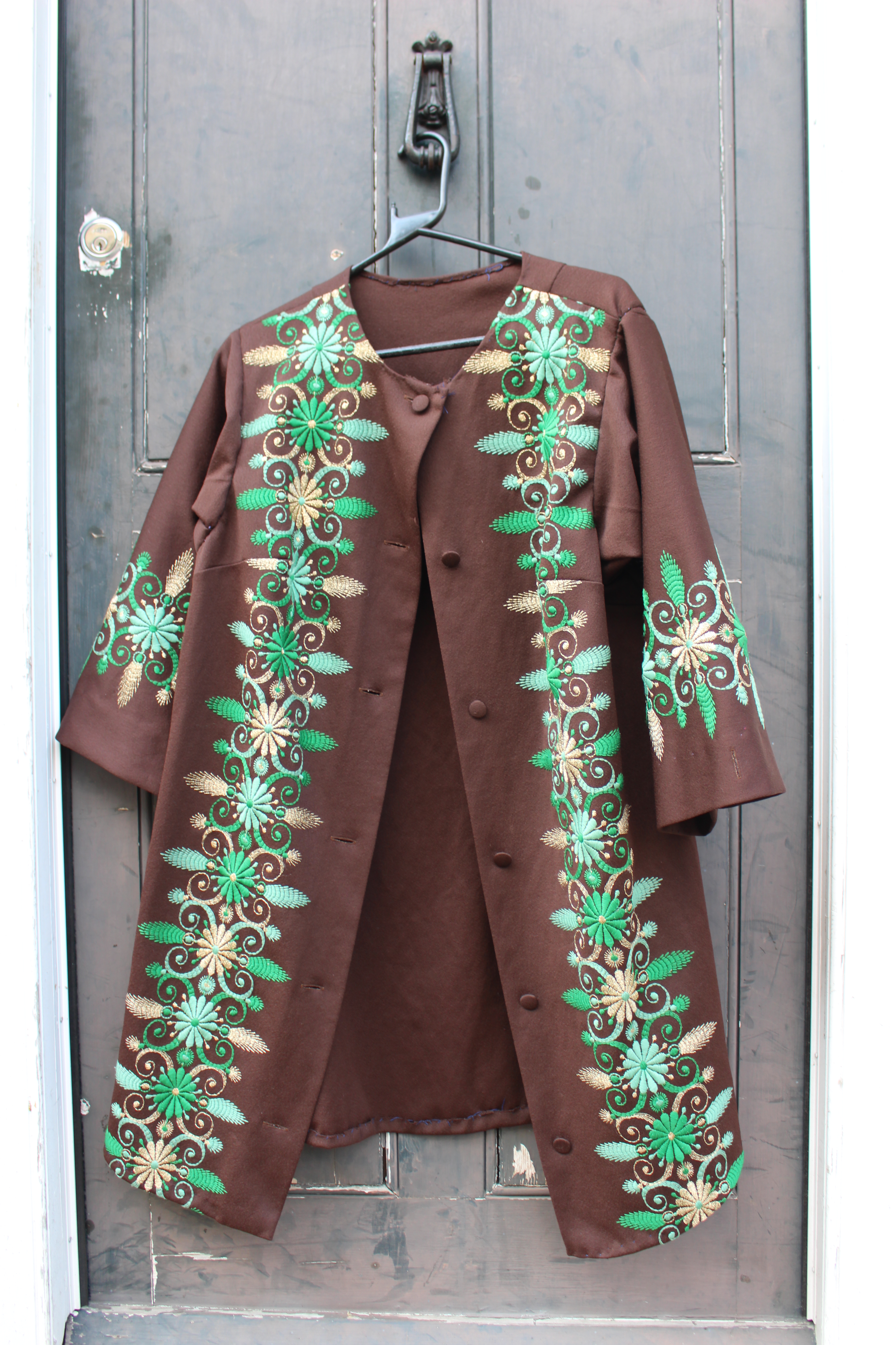 Brown coat embroidered with green and gold