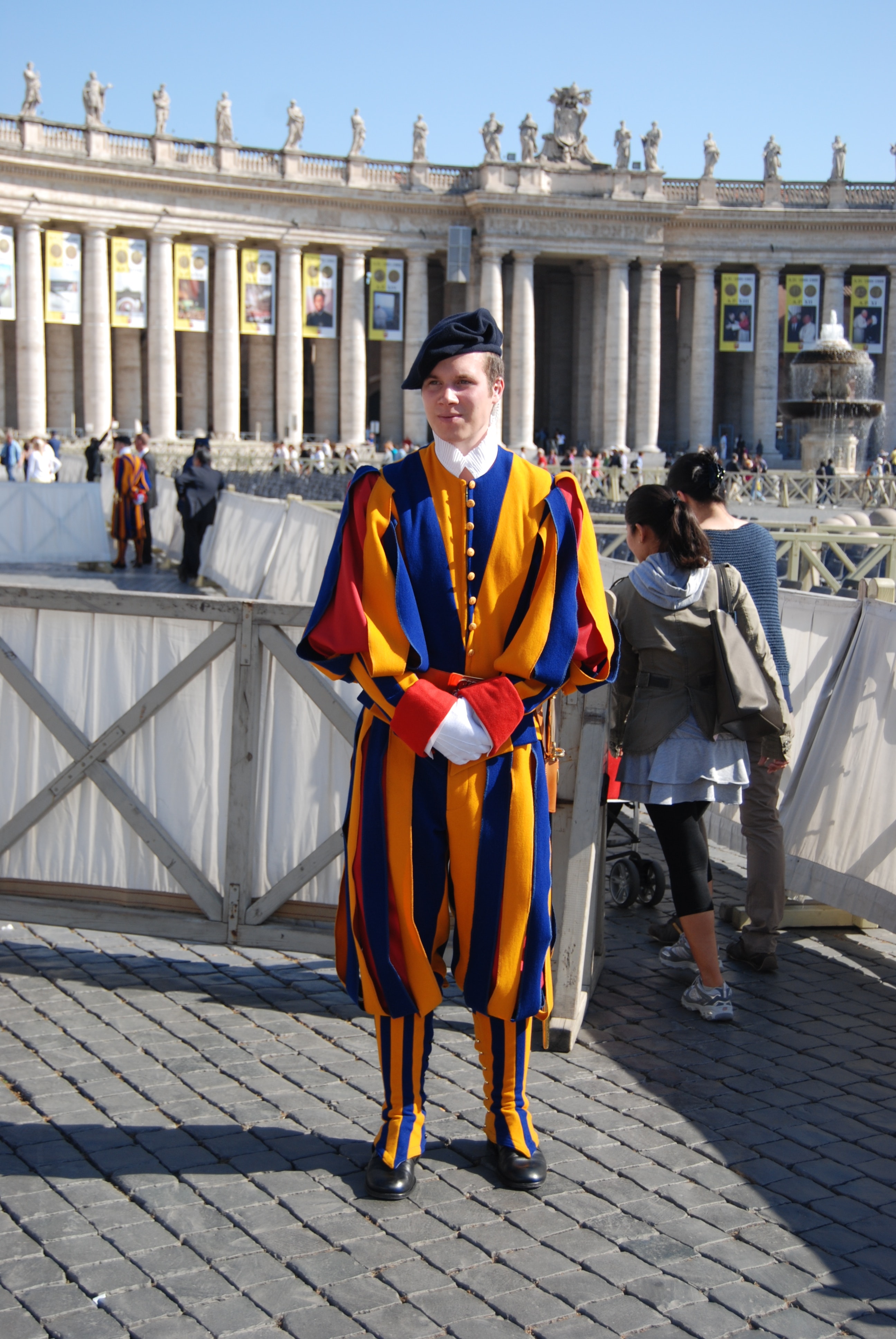 A member of the Pontifical Swiss Guard, in his 
colourful blue, yellow, and red uniform.