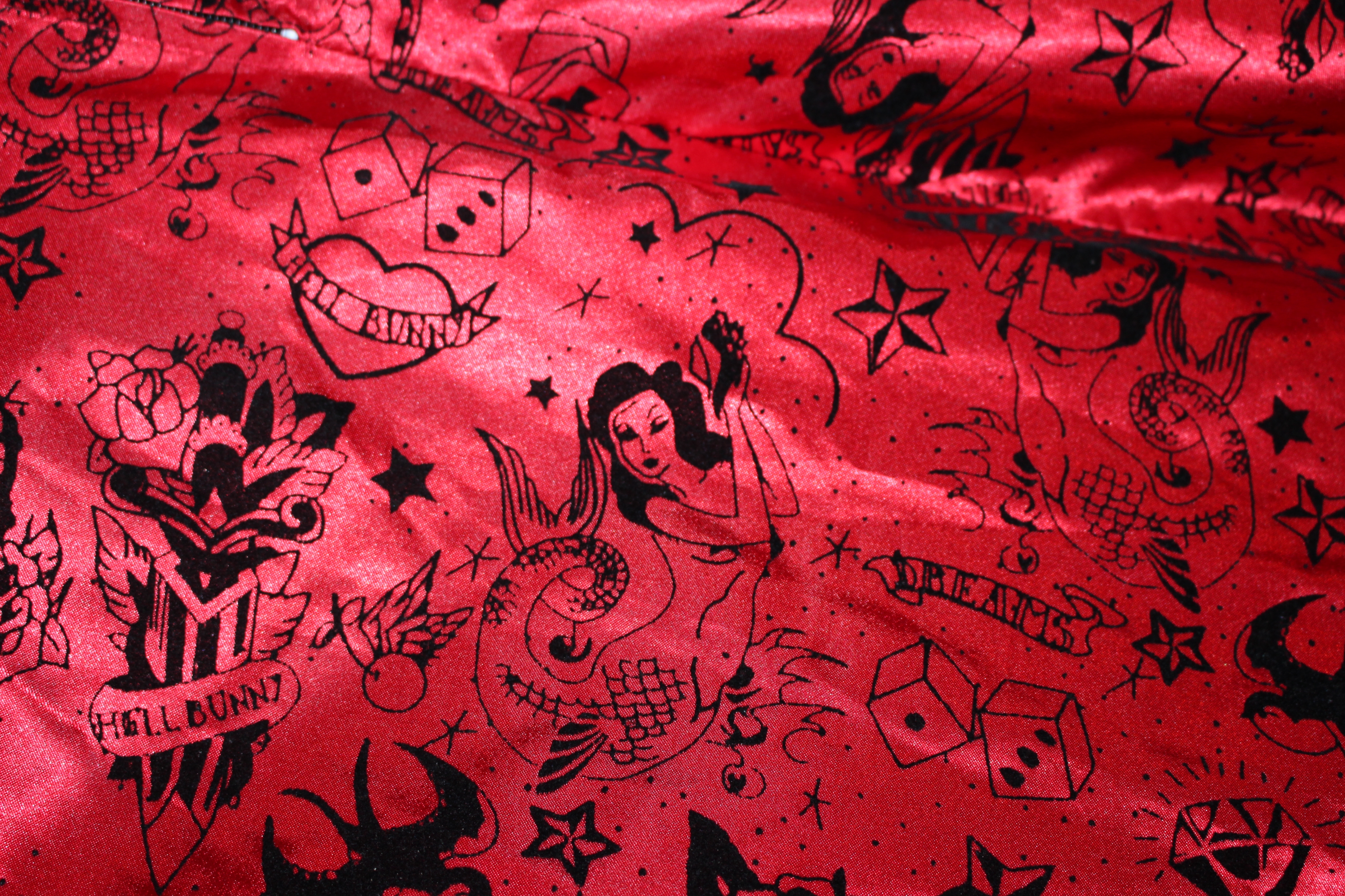 Scarlet satin dress with printed 'devil-dice' motifs